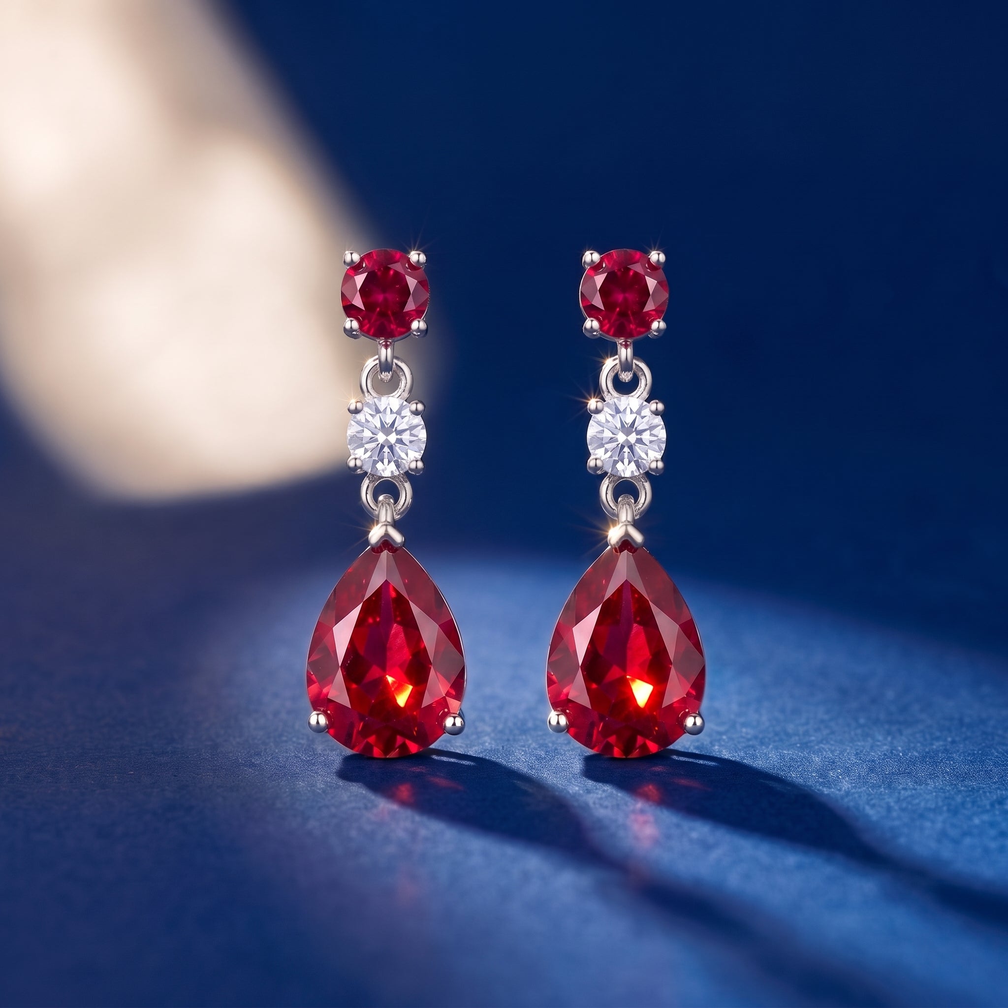 Red pear drop earrings on royal blue